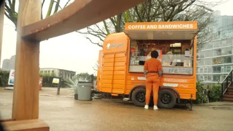 James working at a coffee cart