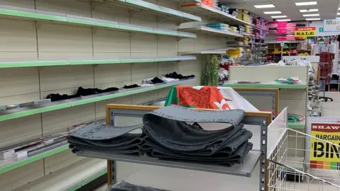 Empty shelves inside Shaws store