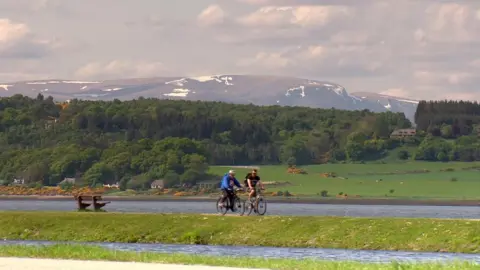 BBC Cyclists alongside Loch Ness in Scotland