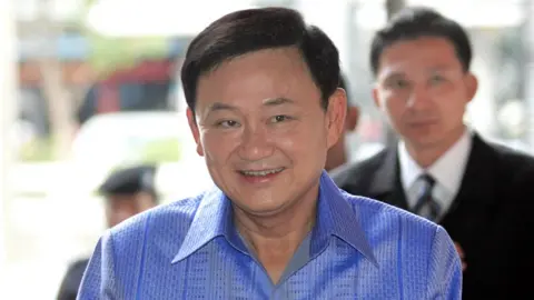 AFP Thai Prime Minister Thaksin Shinawatra smiles as he arrives at Government House in Bangkok, 04 April 2006