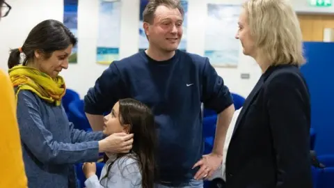 Liz Truss Nazanin Zaghari-Ratcliffe looks into daughter Gabriella's eyes while Richard Ratcliffe and Liz Truss stand near by