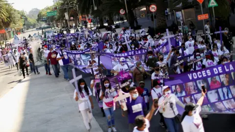 Reuters Relatives and friends of victims of femicide hold a march in Mexico City
