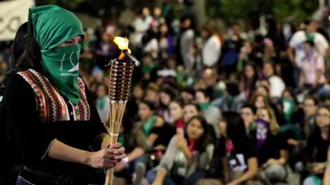  AFP/Getty Images An activist holds a torch during a protest in the framework of the International Day for the Eradication of Violence against Women in Guadalajara, Mexico, on November 25, 2019. (Photo by Ulises Ruiz / AFP) (Photo by ULISES RUIZ/AFP via Getty Images)