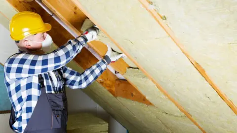 Loft insulation being fitted