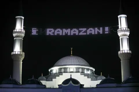 Getty Images A mosque with an electronic sign saying Ramazan