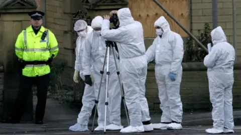 Getty Images Police officers in Morley Road, Bradford