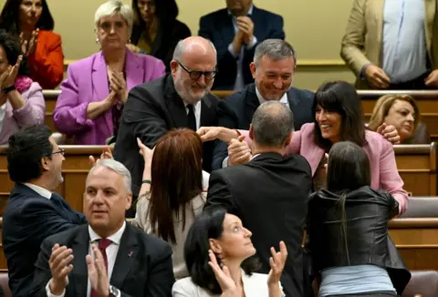 Getty Images MPs for the Together for Catalonia party celebrate the passing of the amnesty law inside the lower house in Madrid