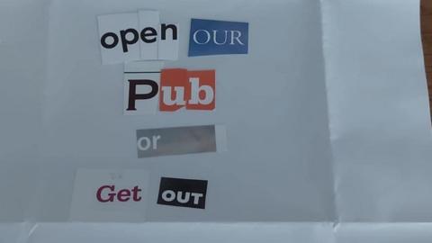 White paper letter with the words Open Our Pub Or Get Out pasted on it a collection of different typefaces   