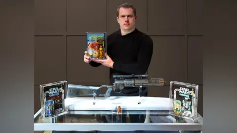 Hansons Auctioneers Toy expert David Wilson-Turner with Star Wars memorabilia, which went to auction in Derbyshire on 5 May 2026.
