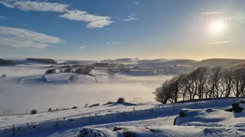 A field covered in snow and fog