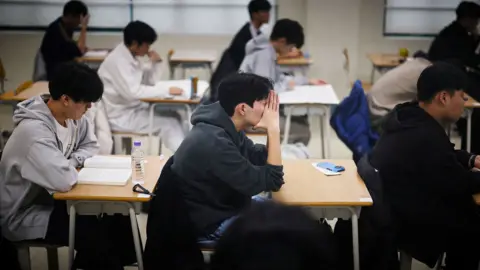 Reuters Students wait for the start of the annual college entrance examinations, also known as Suneung, at an exam hall in Seoul