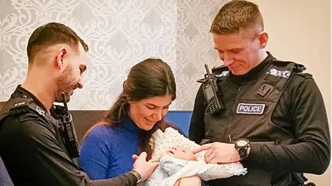 PA Left to right: PC Tom Cannon, Kale Hamakirm (baby's mother), Mahamed Hawser and PC Dom Taylor during the reunion 