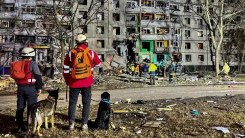 Reuters Emergency personnel work at a site of an apartment building hit by a Russian air strike, amid Russia's attack on Ukraine, in Kharkiv, Ukraine November 8, 2024