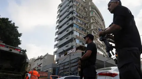 Reuters Police standby at the site of an explosion, amid the Israel-Hamas conflict, in Tel-Aviv, Israel.