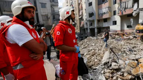 Reuters Medical personnel work at the site of Friday's Israeli strike, as search and rescue operations continued on Saturday