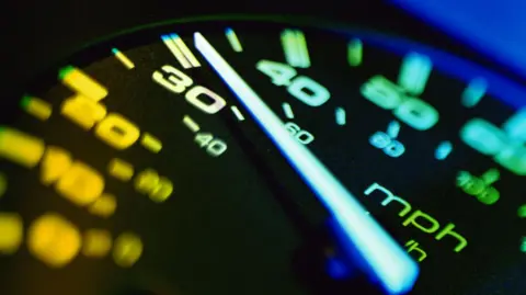 A close-up picture of a car's speedometer. 