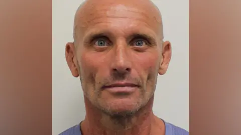 National Crime Agency/PA Wire A police-style mug shot showing Steven Bullen's head and neck. He is looking straight ahead and is wearing a mauve T-shirt.