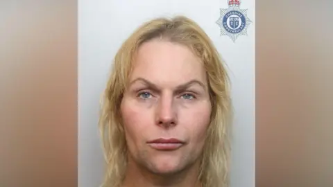 Cheshire Police A mugshot of a person with arched eyebrows and long yellow hair. 