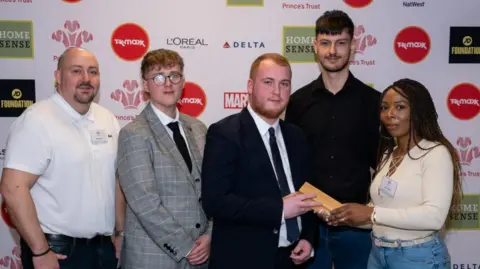 ETC The team, including Charlie, second from right, which designed the 'Tree of Life'