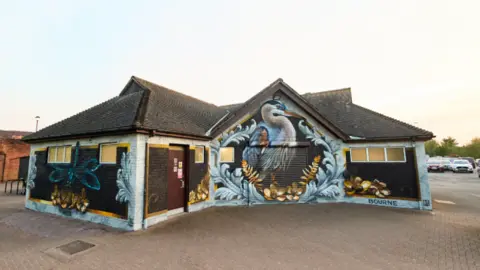 A mural of a bird on a building