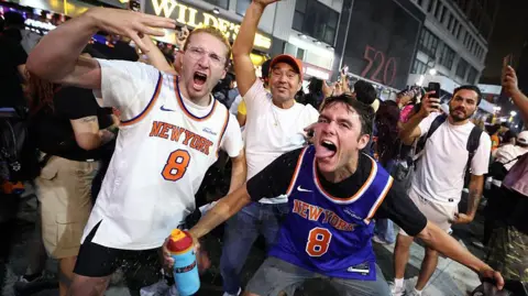 New York Knicks fans celebrate outside Madison Square Garden after their team's Game 4 victory over the San Antonio Spurs in the NBA Finals in New York.