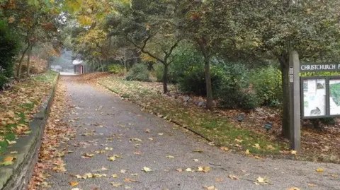 Geographer/Geograph A path in Christchurch Park in Ipswich, Suffolk. There is a sign to the right of the picture with a map which says CHRISTCHURCH PARK. 