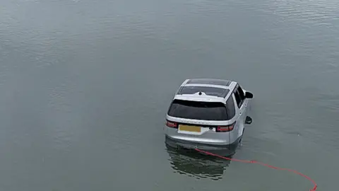 Land Rover Discovery in water off Abersoch