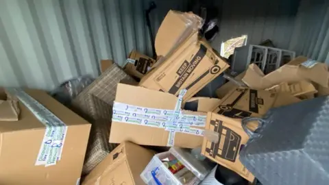 Richard Thomas Brown boxes all discarded and ripped open, messily chucked about the place. 