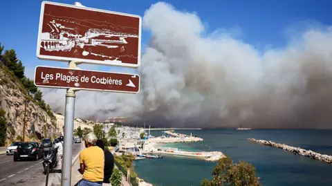 Getty Images Smoke rises above the port of Marseille