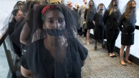 EPA Women with black veils and black tape over their mouths in protest of Kavanaugh line up outside the hearing room