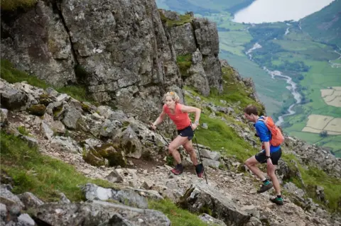 Sam Benard Beth Pascall running across one of the fells as part of the Bob Graham Round