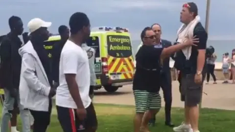 FACEBOOK/ ALAIN AQUADE A still from a social media video that shows a man racially taunting African teenagers in Australia