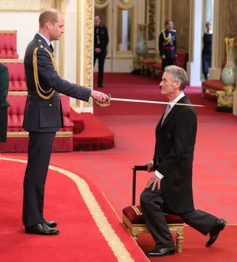 PA The Duke of Cambridge knighting Michael Palin