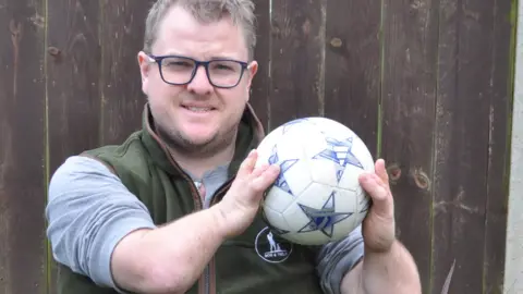 Sam Nunn holding a football