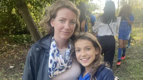 Jams Kelly/BBC Ruth and Ivy Herbert standing side by side.