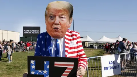 EPA A man dressed as Donald Trump standing with a sign