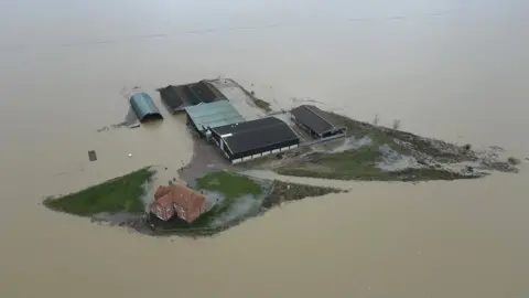 BBC Farmhouse surrounded by water