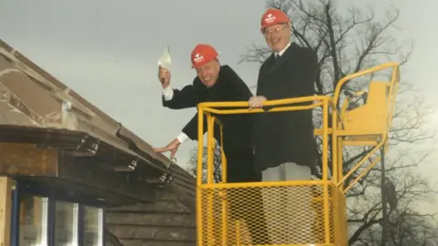 Keech Hospice Care Dennis Keech by a roof