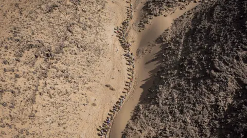 AFP Competitors take part in Stage 3 of the 33rd edition of the Marathon des Sables between Rich Mbirika and Nord El Maharch in the southern Moroccan Sahara desert on April 10, 2018.