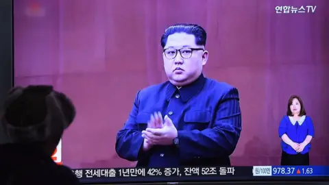 AFP A man watches a television news screen showing North Korean leader Kim Jong Un at a railway station in Seoul on 16 May 2018.