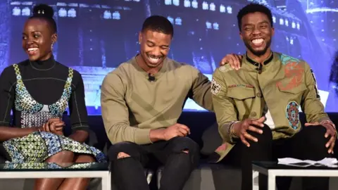 Getty Images for Disney Actors Lupita Nyong'o, Michael B. Jordan, and Chadwick Boseman at a Black Panther press junket