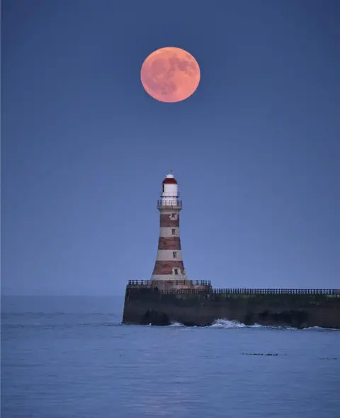 Michael Wake Michael Wake said the Strawberry Moon got brighter and brighter as it rose over Roker Pier in Sunderland