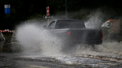 Reuters A man drives his vehicle around the Union Point Park Complex through floodwaters as the Hurricane Florence comes ashore in New Bern