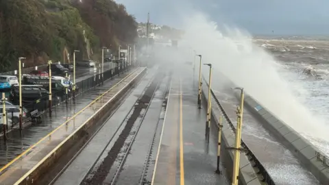 Waves crash over the railway line at Dawlish
