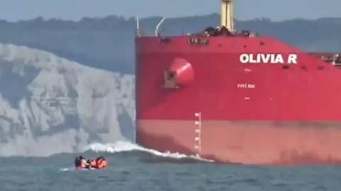 Migrant dinghy dwarfed by tanker in English Channel