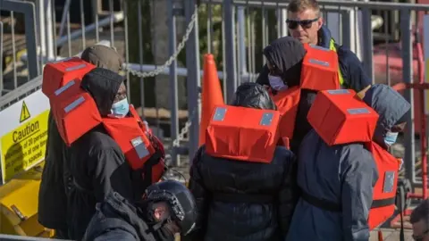 EPA Officials picked up a boat carrying migrants in the English Channel, in Dover, on 9 May 2022