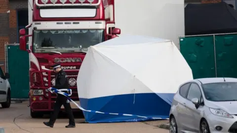 EPA Officers inspect a lorry in Essex after finding 39 bodies inside