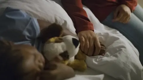 Getty Images Parent with sleeping child