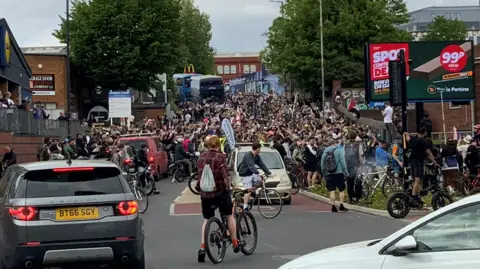 Hundreds of cyclists are seen causing congestion on a road in Bedminster in south Bristol during the Bristol Drum & Bass Bike Ride