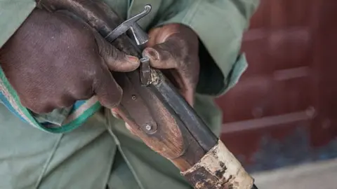 AFP Man holding an old fashioned rifle known as a dane gune